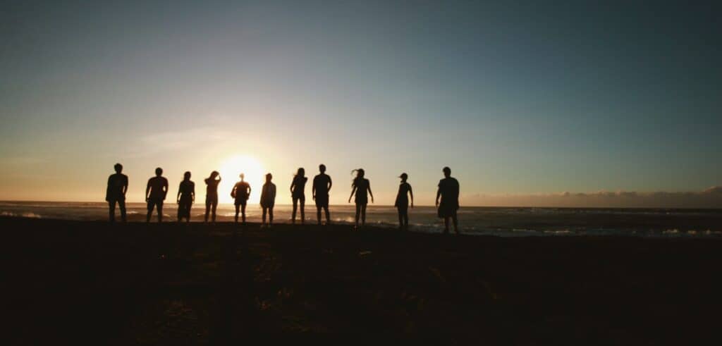 Image of people at a distance in silhouette. 