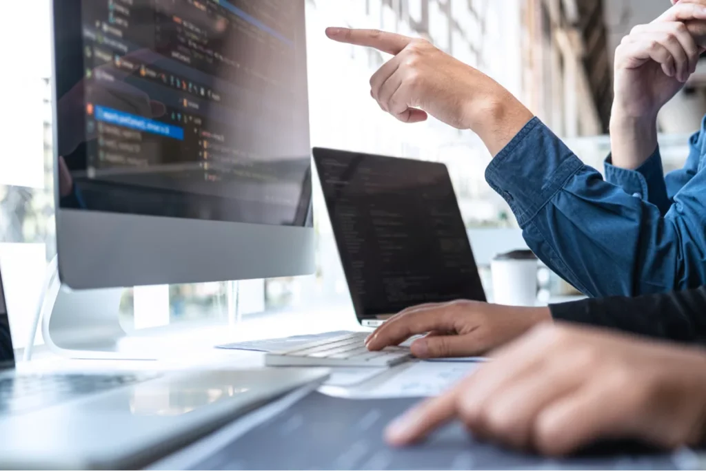 An image of people sitting at a computer, looking at an SSL certificate in regards to securing your Reg CF Crowdfunding Portal