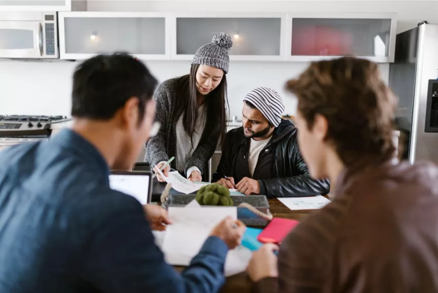 A photo of a crowd of people discussing fundraising strategy