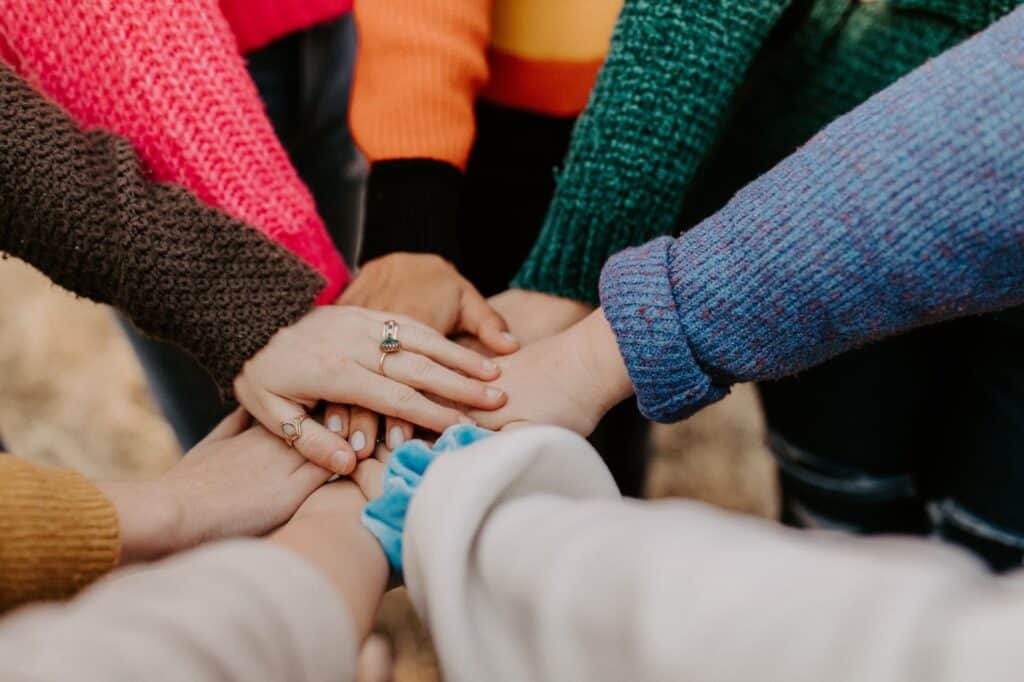 A photo of a group of women holding hands