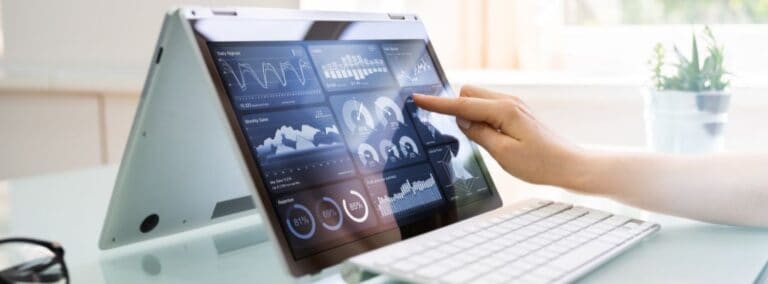 an image of a touch screen laptop being touched